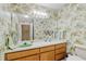 Cozy bathroom featuring playful animal print wallpaper and well lit vanity with storage at 2208 Guinevere Ne Way, Atlanta, GA 30345