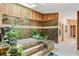 Unique bathroom featuring a tiled soaking tub, skylight, and lots of plants at 2208 Guinevere Ne Way, Atlanta, GA 30345