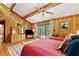 Sunlit bedroom with vaulted ceilings, wood paneling, deck access, and comfortable furnishings at 2208 Guinevere Ne Way, Atlanta, GA 30345