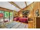 Charming bedroom features wood paneling, vaulted ceilings, and sliding doors to a private deck at 2208 Guinevere Ne Way, Atlanta, GA 30345