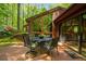 Lovely deck with outdoor dining set features a smooth transition to the indoor spaces through sliding glass doors at 2208 Guinevere Ne Way, Atlanta, GA 30345