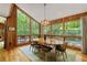 Dining room with a wood table, many windows, and view of the surrounding nature at 2208 Guinevere Ne Way, Atlanta, GA 30345