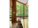 Dining room features hardwood floors, wooden walls, and an oversized picture window to view the greenery outdoors at 2208 Guinevere Ne Way, Atlanta, GA 30345