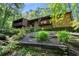 Hillside home with balconies and stone accents surrounded by lush landscaping at 2208 Guinevere Ne Way, Atlanta, GA 30345
