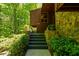 Exterior steps lead to the front entrance, surrounded by greenery and featuring stone accents at 2208 Guinevere Ne Way, Atlanta, GA 30345