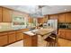 Spacious kitchen featuring stainless steel appliances and a large island with seating and a view of the garden at 2208 Guinevere Ne Way, Atlanta, GA 30345