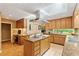 A spacious kitchen features stainless steel appliances, granite counters, an island cooktop, and backyard views at 2208 Guinevere Ne Way, Atlanta, GA 30345