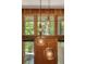 Close-up of modern pendant lighting with a view of the wooded exterior at 2208 Guinevere Ne Way, Atlanta, GA 30345