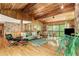 Comfortable living room with wood-paneled walls, hardwood flooring, stone fireplace, and outdoor views at 2208 Guinevere Ne Way, Atlanta, GA 30345