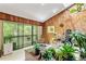 Living room with wood paneled walls, plants, and sliders opening to a balcony at 2208 Guinevere Ne Way, Atlanta, GA 30345