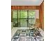 Living room with rocking chair and sliders opening to a balcony overlooking trees at 2208 Guinevere Ne Way, Atlanta, GA 30345