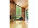 Bright living room features hardwood floors, an impressive stone fireplace, and an oversized picture window with outdoor views at 2208 Guinevere Ne Way, Atlanta, GA 30345