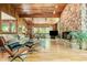 Living room features wood-paneled walls, stone fireplace, and large windows allowing ample natural light at 2208 Guinevere Ne Way, Atlanta, GA 30345
