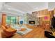 Living room with wood paneled walls, a stone fireplace, and retro furniture at 2208 Guinevere Ne Way, Atlanta, GA 30345