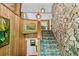 Carpeted staircase with stone wall and wooden railing at 2208 Guinevere Ne Way, Atlanta, GA 30345