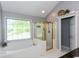 A bathroom featuring a tub and shower with a gold frame and white tiled surround at 3011 Oak Hampton Ct, Duluth, GA 30096