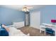 A secondary bedroom boasts blue walls, fan, and white furniture at 3011 Oak Hampton Ct, Duluth, GA 30096