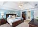 A primary bedroom boasts blue walls, trey ceiling, fan, and dark wood furniture at 3011 Oak Hampton Ct, Duluth, GA 30096
