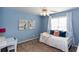 A secondary bedroom boasts blue walls, fan, and a daybed with throw pillows at 3011 Oak Hampton Ct, Duluth, GA 30096
