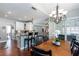 Open dining area features a stylish chandelier and breakfast bar with kitchen access at 3011 Oak Hampton Ct, Duluth, GA 30096