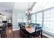 Dining room boasts a large window, dark wood floors and open floorplan concept at 3011 Oak Hampton Ct, Duluth, GA 30096