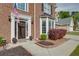 Close up of the home's front entrance with brick facade and tidy landscaping at 3011 Oak Hampton Ct, Duluth, GA 30096