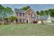 Classic brick two-story home with well-manicured lawn and landscaping, showcasing traditional American architecture at 3011 Oak Hampton Ct, Duluth, GA 30096