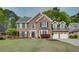 Charming two-story brick home with manicured lawn and a two car garage at 3011 Oak Hampton Ct, Duluth, GA 30096