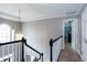 Upstairs hallway boasts natural light with views to a bedroom at 3011 Oak Hampton Ct, Duluth, GA 30096