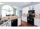 Bright kitchen features granite countertops, stainless steel appliances, and a large arched window at 3011 Oak Hampton Ct, Duluth, GA 30096