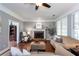 A hardwood living room with a brick fireplace and two large sofas at 3011 Oak Hampton Ct, Duluth, GA 30096