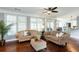 Bright living room with hardwood floors, neutral couches, and large windows at 3011 Oak Hampton Ct, Duluth, GA 30096