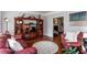 Cozy living room features hardwood floors, a red leather sofa, and custom built-in shelves for stylish storage at 3011 Oak Hampton Ct, Duluth, GA 30096
