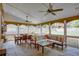 Large screened-in porch with a ceiling fan, dining table, and comfortable lounge area at 3011 Oak Hampton Ct, Duluth, GA 30096