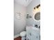 Stylish powder room with marble countertop, modern faucet, decorative mirror, and sconce lighting at 3011 Oak Hampton Ct, Duluth, GA 30096