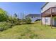 Backyard features a grassy lawn and wooded backdrop at 4357 James Wade Dr, Snellville, GA 30039
