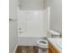 Bathroom with shower-tub combo and wood look flooring at 4357 James Wade Dr, Snellville, GA 30039