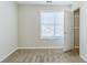 Bedroom showing a window, carpet, and a walk-in closet at 4357 James Wade Dr, Snellville, GA 30039