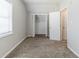 Bright bedroom showcasing closet and neutral carpet at 4357 James Wade Dr, Snellville, GA 30039