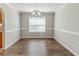 Formal dining room with elegant chandelier, crown molding, and large window at 4357 James Wade Dr, Snellville, GA 30039