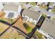 Aerial view of the backyard featuring a garden, fence, and covered patio area at 81 Creekside Bluff Way, Auburn, GA 30011