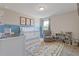 Charming Bedroom featuring a crib, glider, and colorful decor, perfect for a new baby at 81 Creekside Bluff Way, Auburn, GA 30011