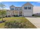 Charming two-story home featuring a welcoming front porch and well-manicured lawn at 81 Creekside Bluff Way, Auburn, GA 30011