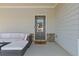 Comfortable front porch seating area with a view of the home's entrance at 81 Creekside Bluff Way, Auburn, GA 30011