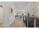 Spacious hallway with hardwood floors and elegant decor leading to the dining area at 81 Creekside Bluff Way, Auburn, GA 30011