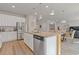 Spacious kitchen featuring an island with granite countertops and stainless steel appliances at 81 Creekside Bluff Way, Auburn, GA 30011
