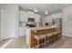 Stylish kitchen with a central island, seating, and stainless steel appliances at 81 Creekside Bluff Way, Auburn, GA 30011
