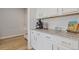 Updated kitchen featuring granite countertops and white cabinets at 81 Creekside Bluff Way, Auburn, GA 30011