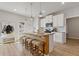 Modern kitchen featuring a spacious island with seating and white cabinetry at 81 Creekside Bluff Way, Auburn, GA 30011