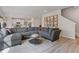 Open-concept living room featuring a large sectional couch and an open layout to the kitchen at 81 Creekside Bluff Way, Auburn, GA 30011